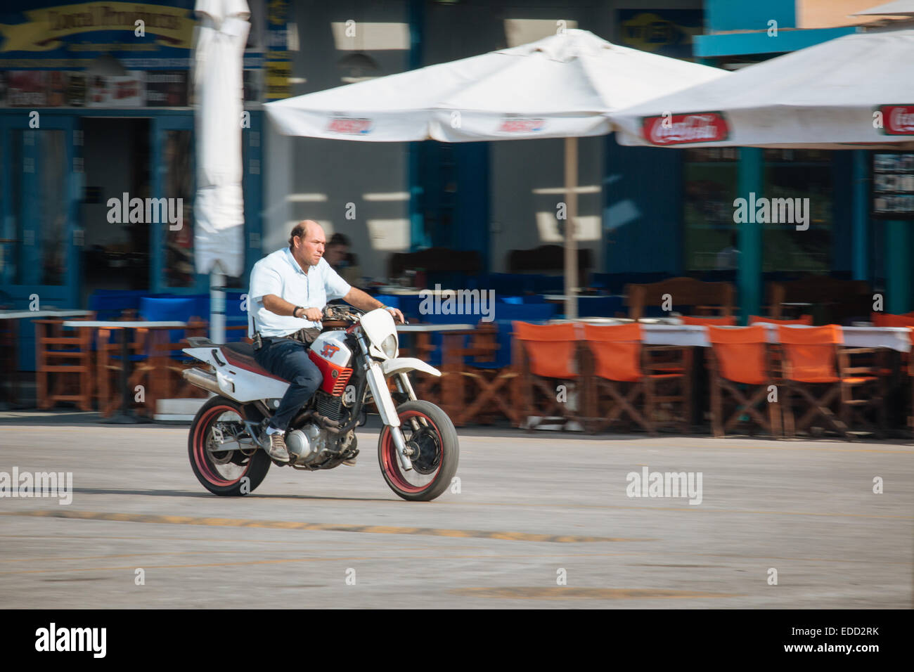 Man on motorcycle in Athinios port, Santorini, Cyclades, Greek islands