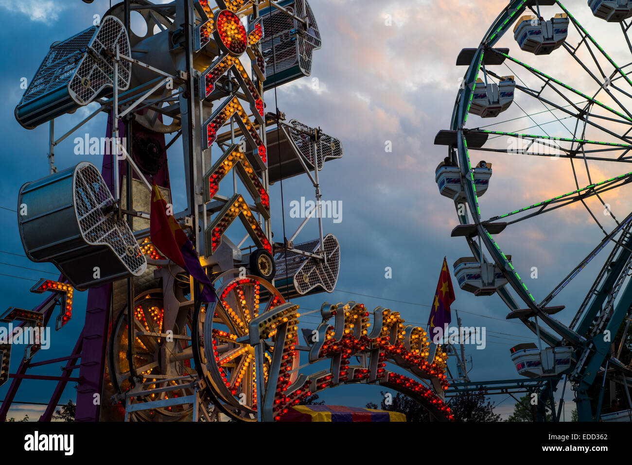 Amusement rides at a county fair at sunset. Stock Photo
