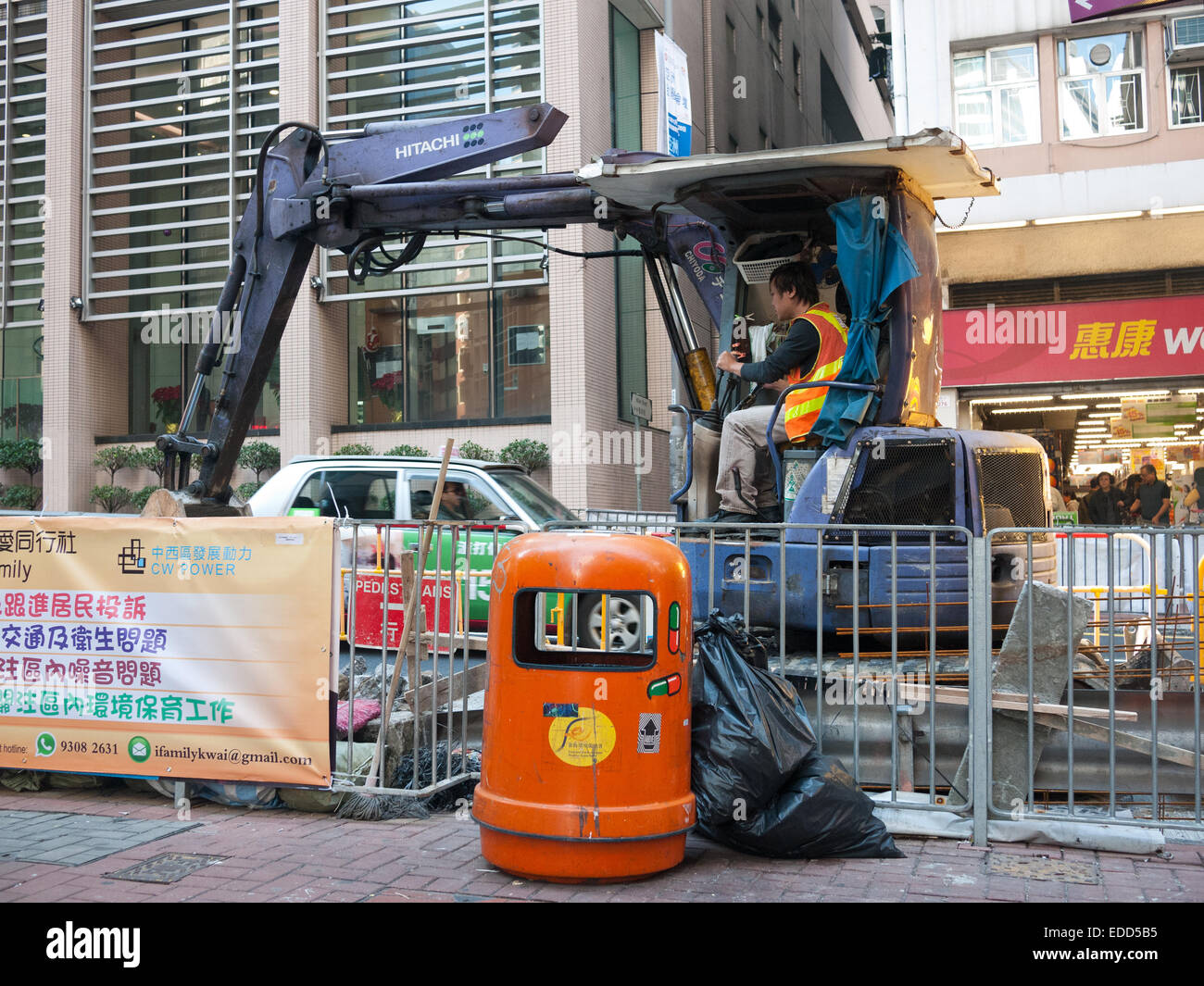 Hong Kong 2015 Man working with wheel tractor-scraper Stock Photo