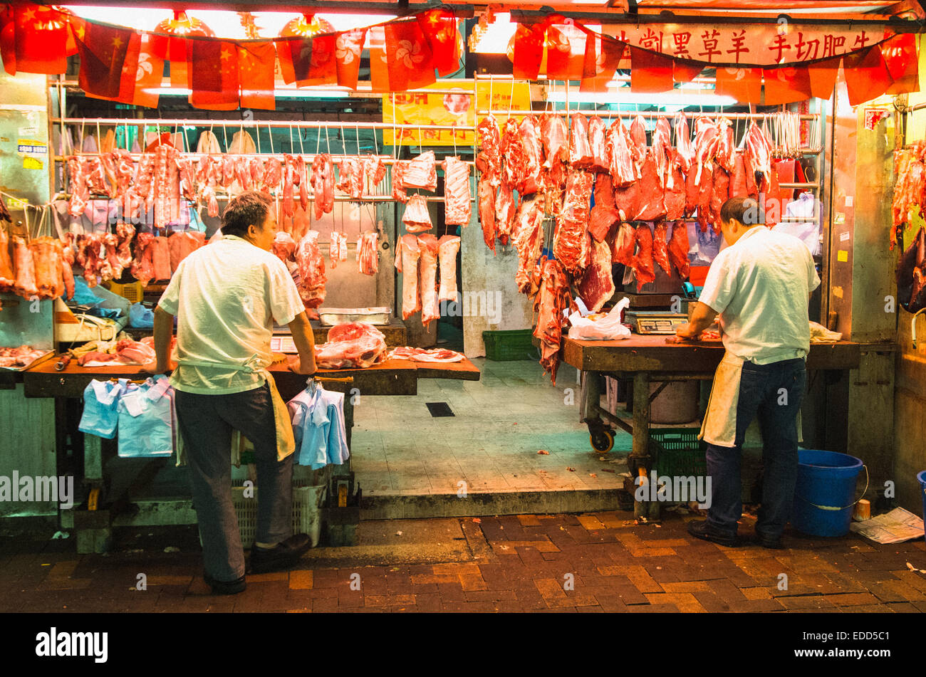 Butchers at night market of Hong Kong, China. Stock Photo