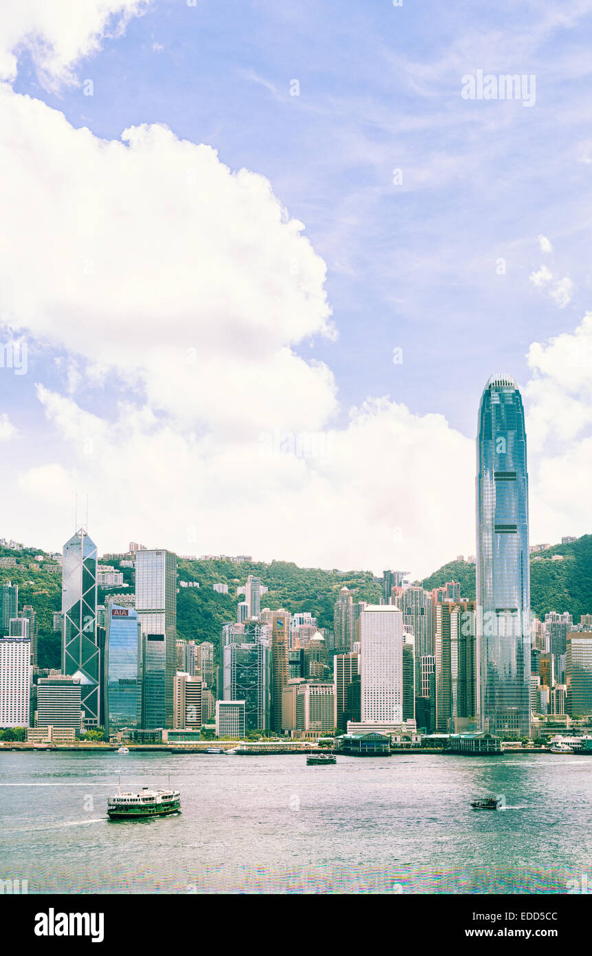 skyline of Hong Kong Victoria Harbour with ferry cruising Stock Photo