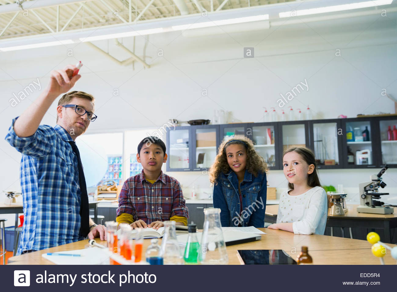 Teacher and elementary students in laboratory Stock Photo