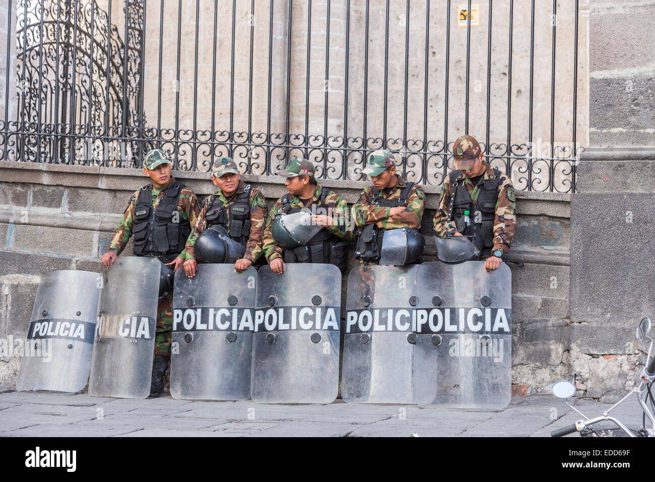 Peruvian riot police wearing camouflage uniform with shields and helmets standing outside Arequipa Cathedral, Plaza de Armas, Arequipa, Peru Stock Photo