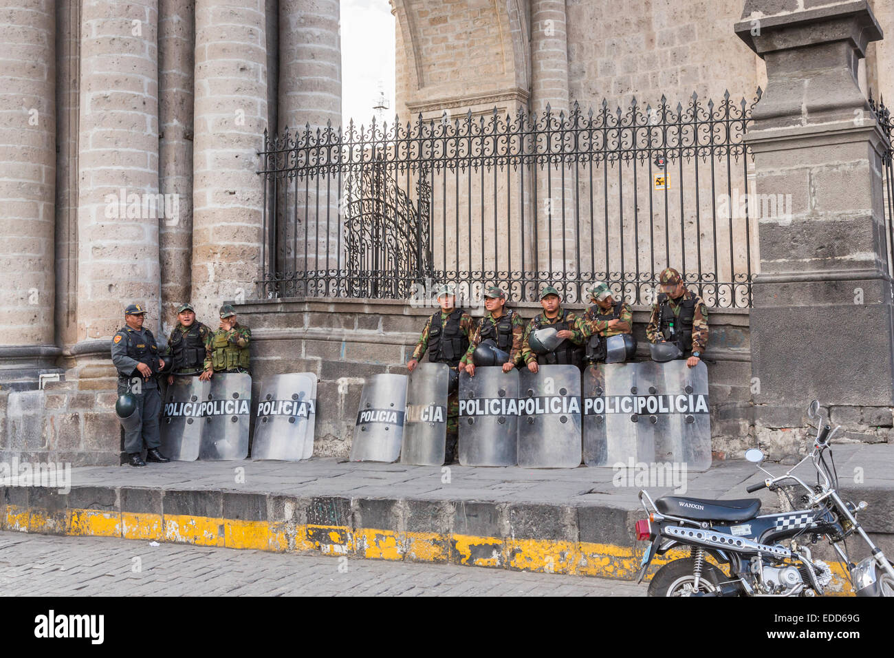 Peruvian riot police wearing camouflage uniform with shields and helmets standing outside Arequipa Cathedral, Plaza de Armas, Arequipa, Peru Stock Photo