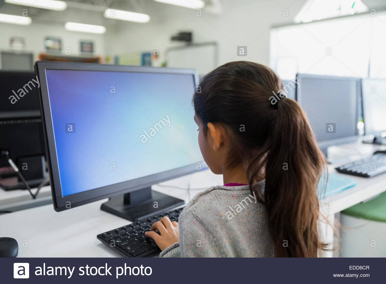 Elementary student using computer in classroom Stock Photo Alamy