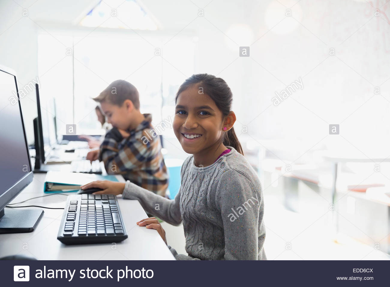 Elementary students using computers in classroom Stock Photo Alamy