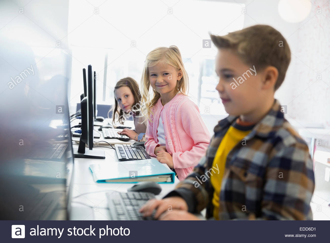 Elementary students using computers in classroom Stock Photo Alamy
