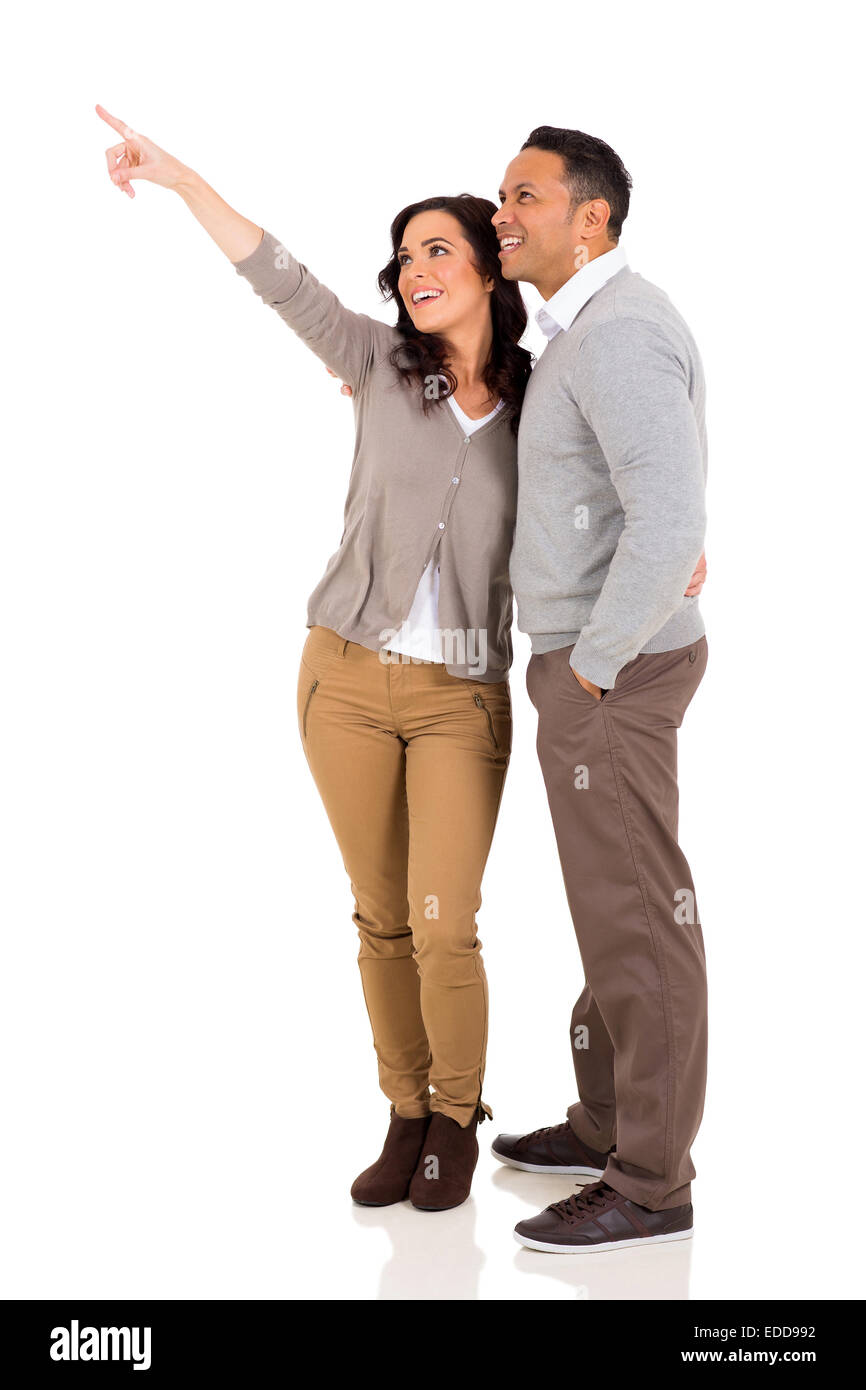 happy married couple pointing on white background Stock Photo - Alamy