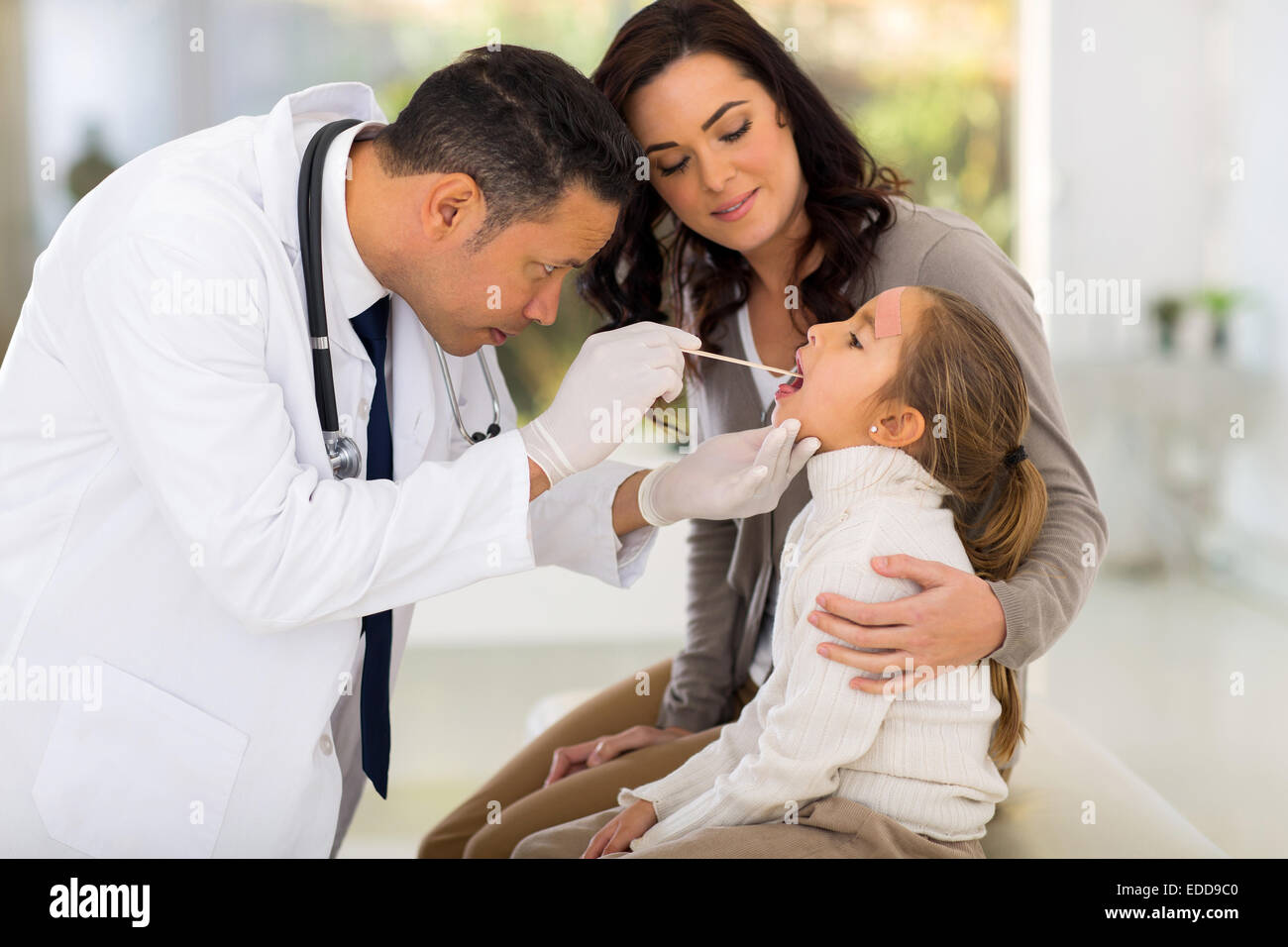 mid age pediatric doctor examining little patient Stock Photo Alamy