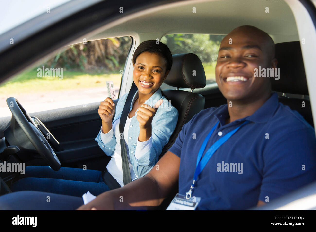 African woman has passed her driving test, holding driver's license Stock Photo