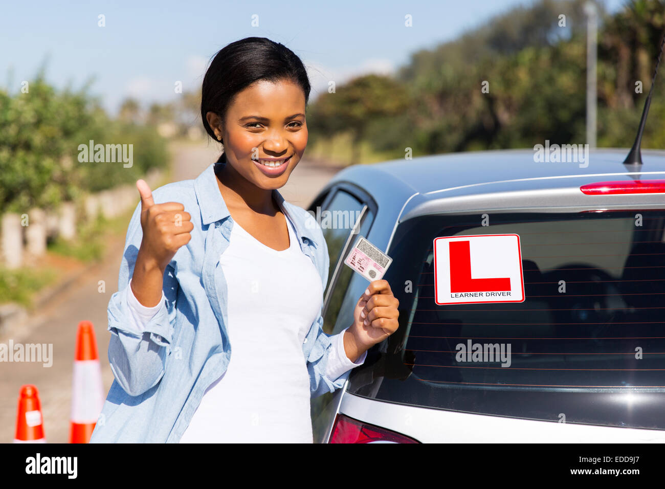 cheerful black woman showing a driving license she just got Stock Photo