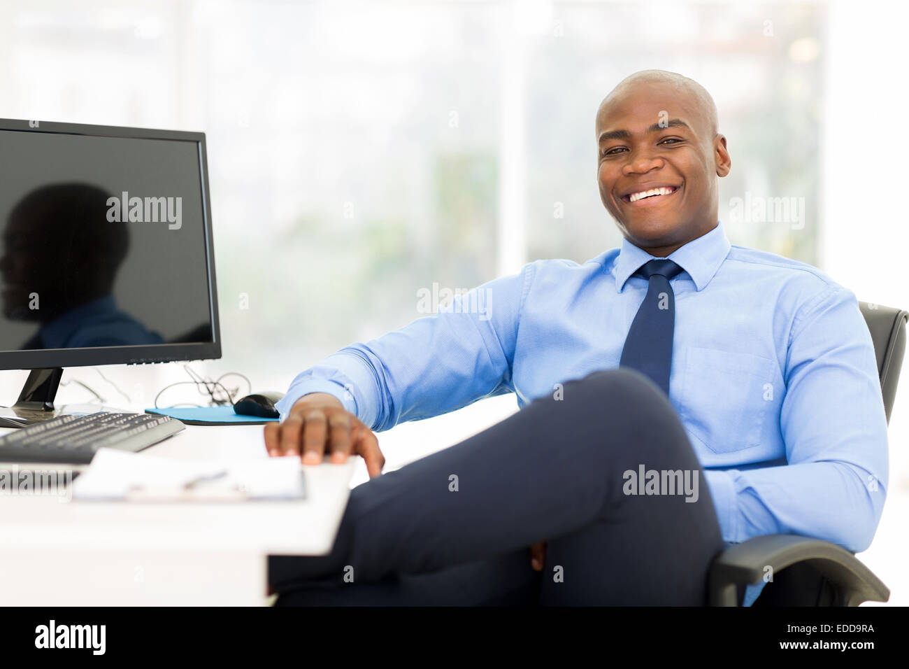 relaxed black businessman sitting in modern office Stock Photo - Alamy, image size:1300x956