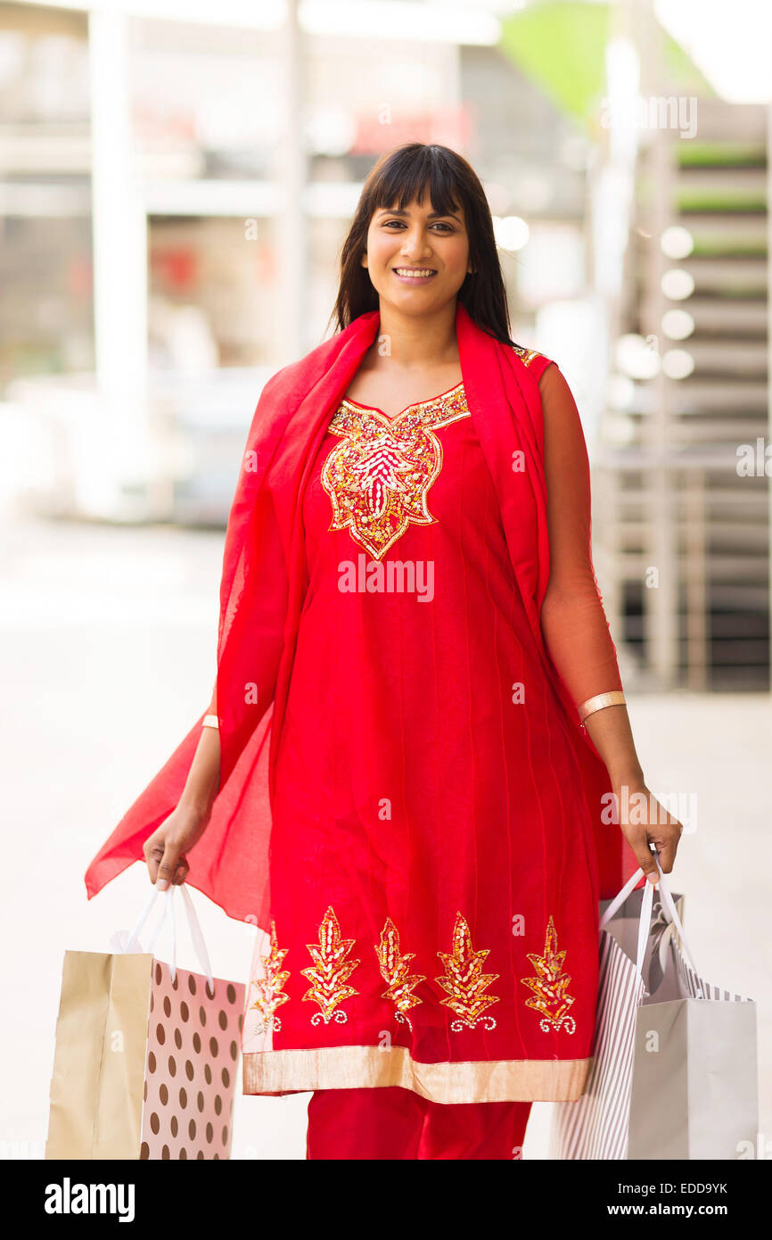 happy Indian woman carrying shopping bags at the mall Stock Photo