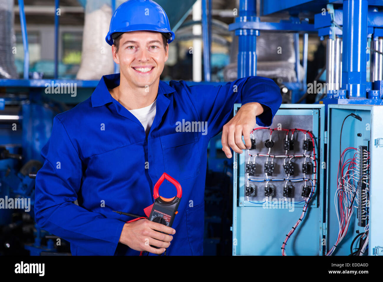 portrait of industrial electrician with insulation tester in factory Stock Photo