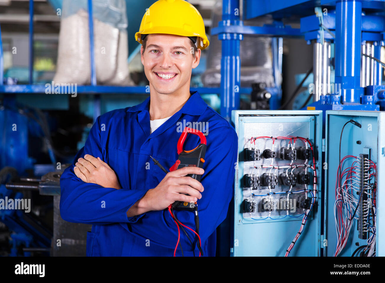 happy electrician holding digital insulation resistance tester Stock Photo