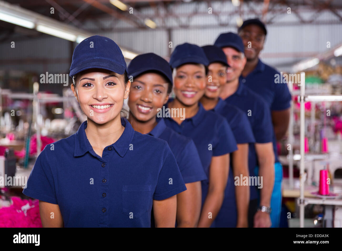 group of machinists line up in clothing factory Stock Photo Alamy