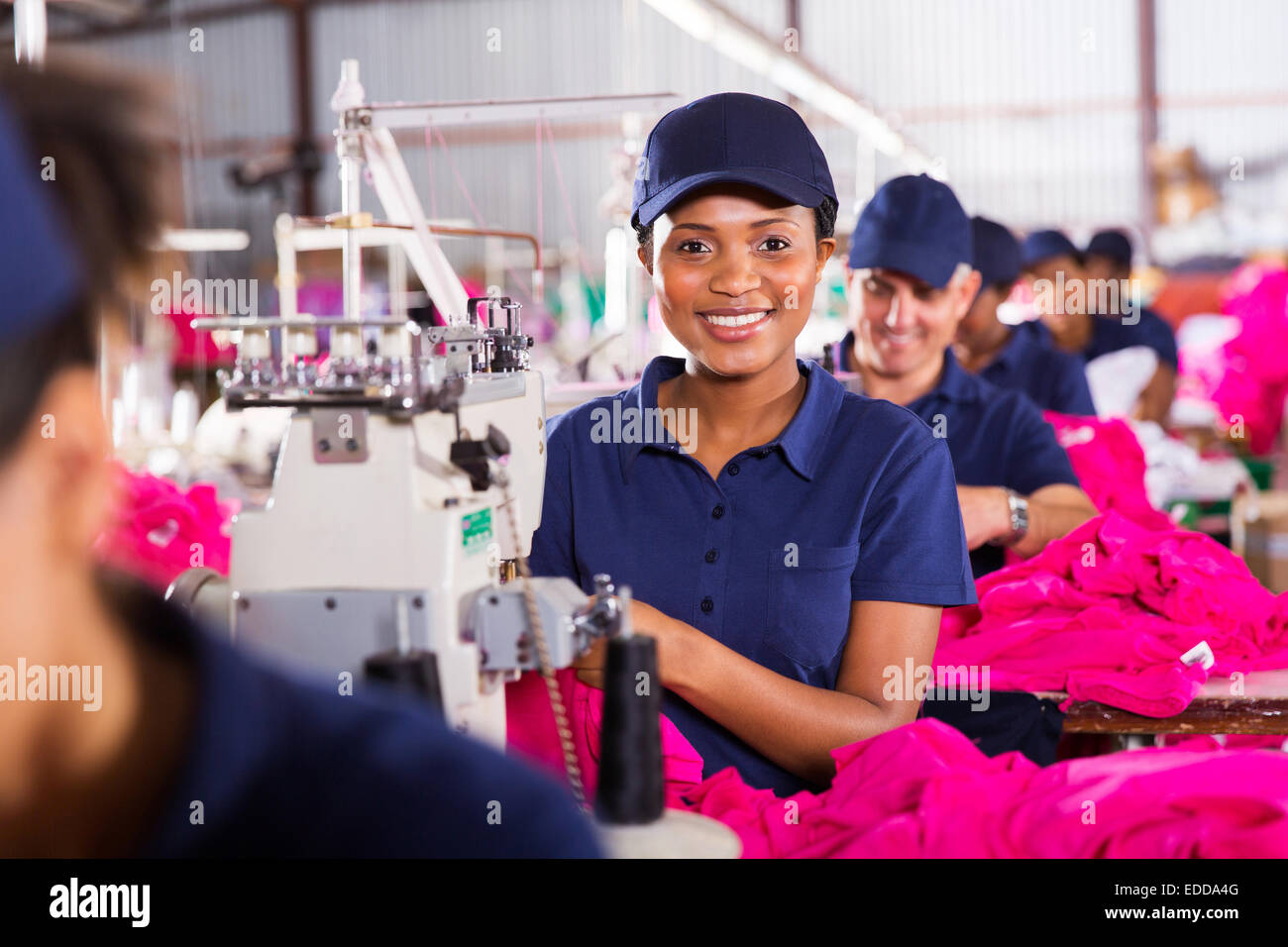 pretty African sewing machinist working in clothing factory Stock Photo