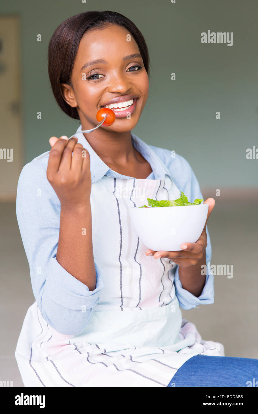 cheerful African woman eating healthy food Stock Photo