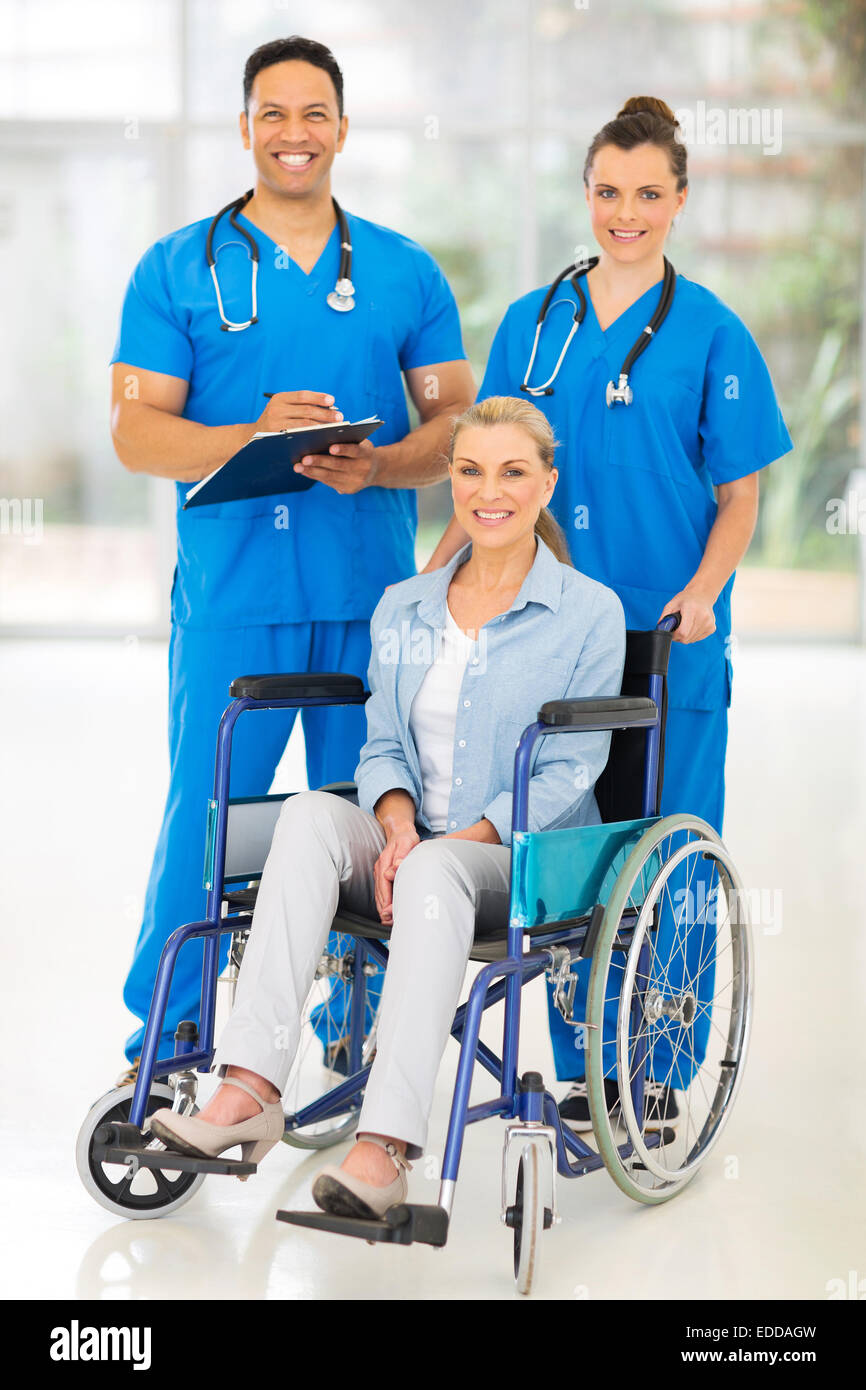 two professional health care workers and disabled patient Stock Photo