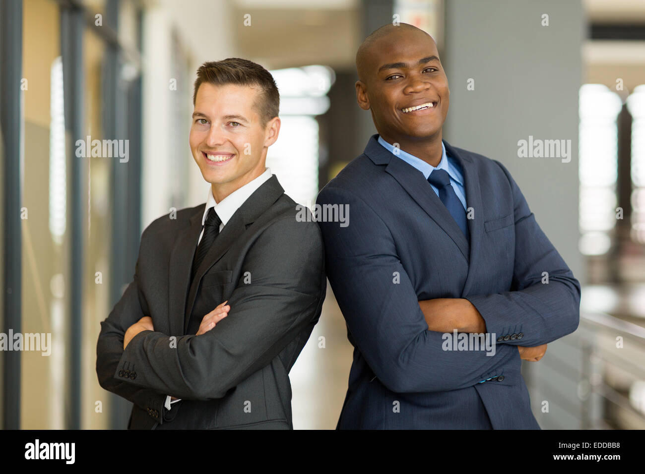 cheerful young businessmen with arms crossed in office Stock Photo - Alamy