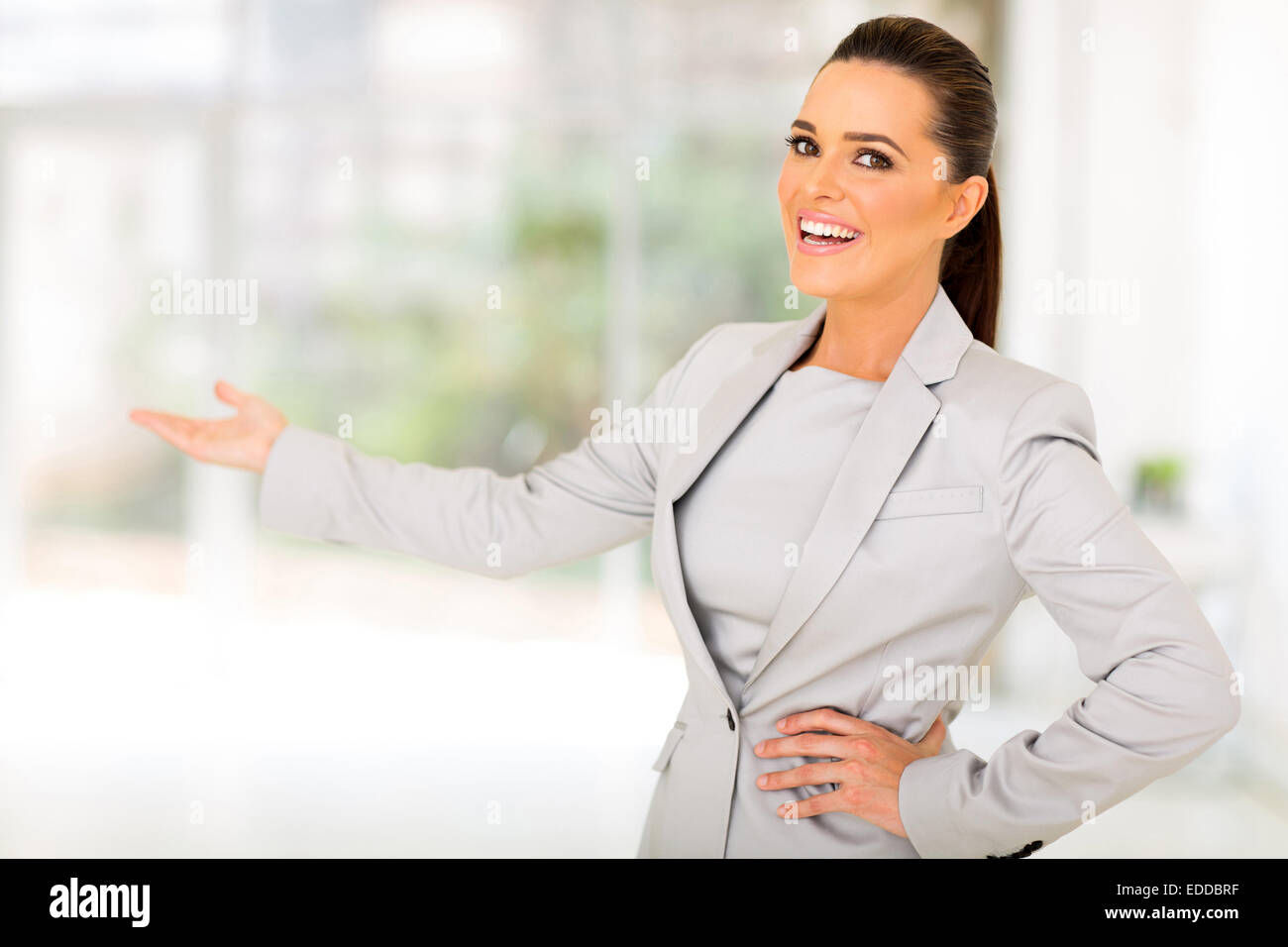 friendly businesswoman doing welcoming gesture Stock Photo