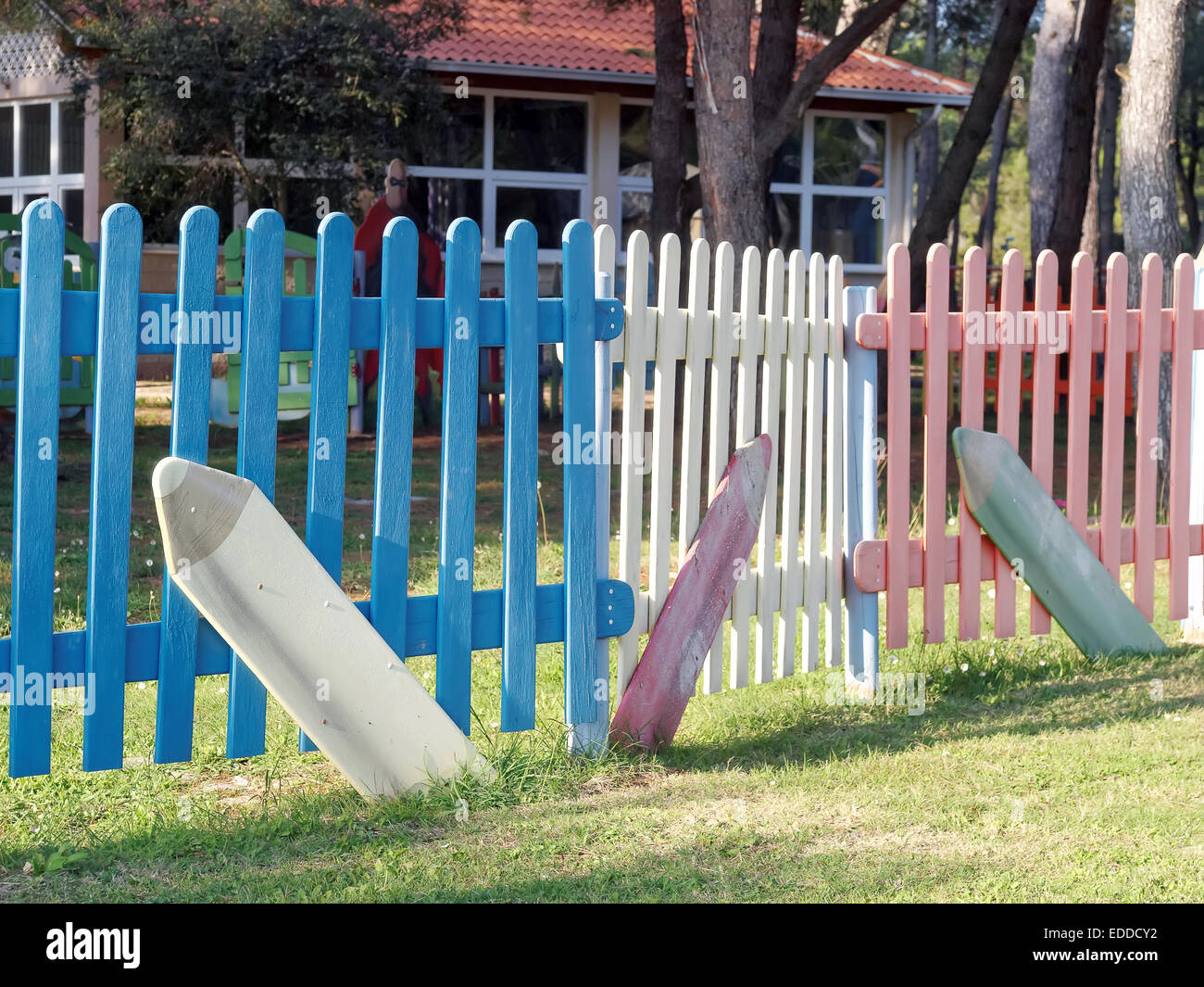 children playground surrounded with wooden colored fence Stock Photo