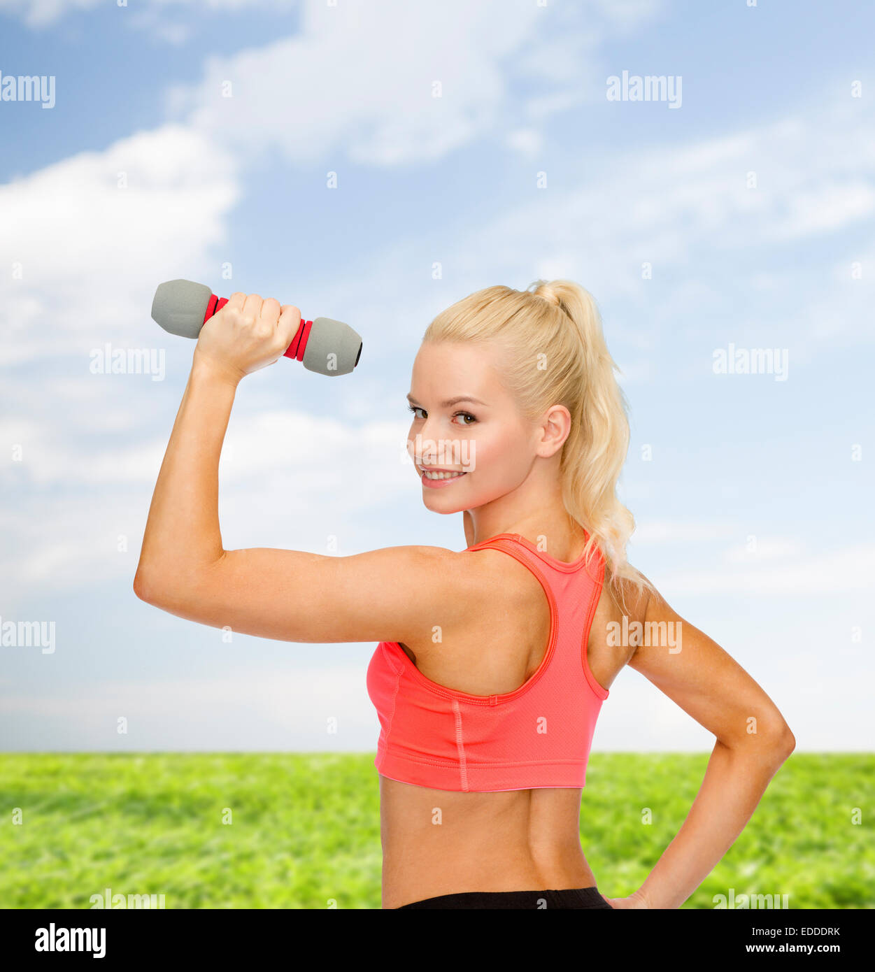 young sporty woman with light dumbbell Stock Photo