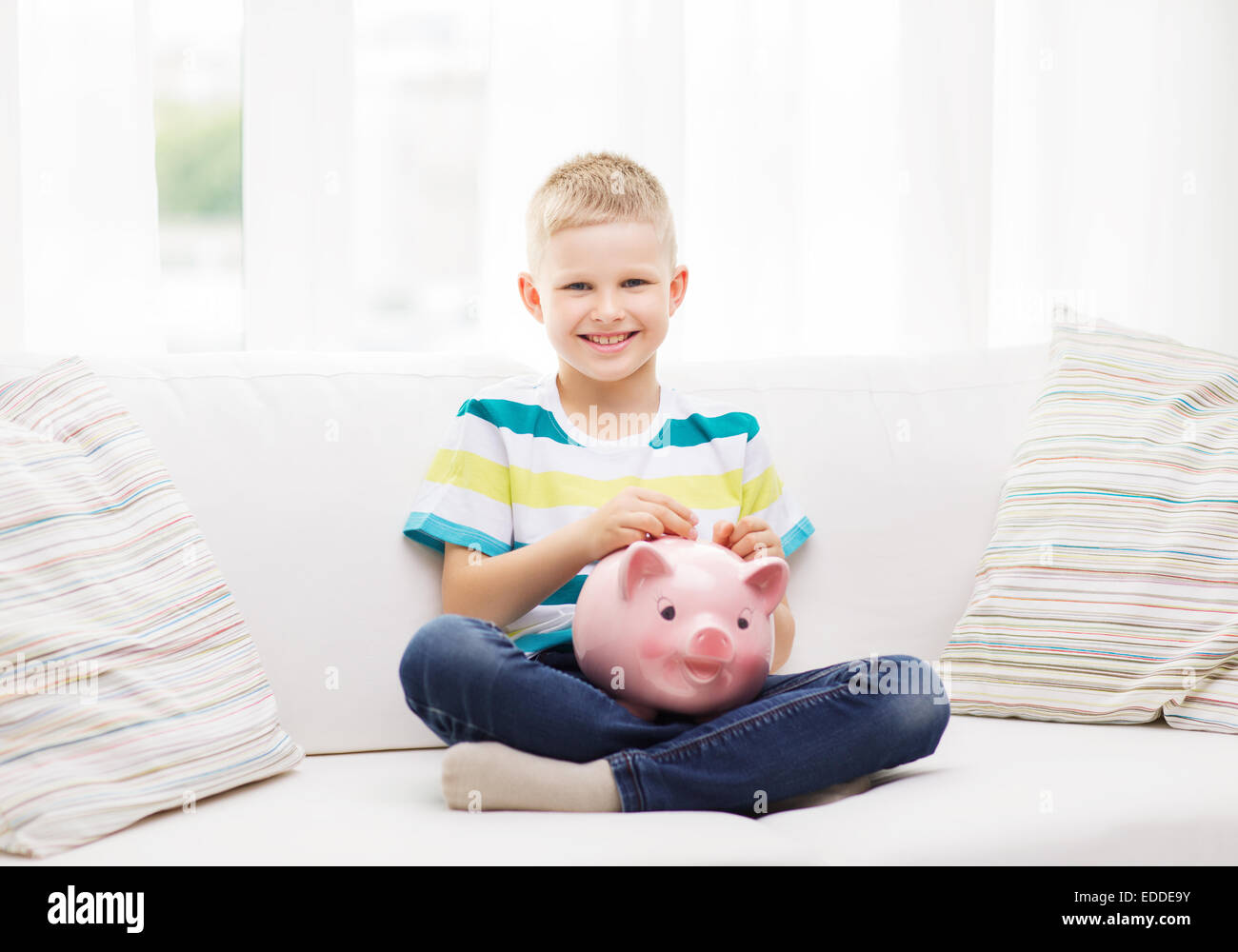 smiling little boy with piggy bank and money Stock Photo - Alamy