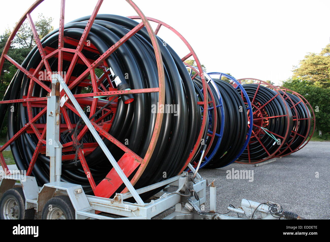 Red cable drum with black cable Stock Photo