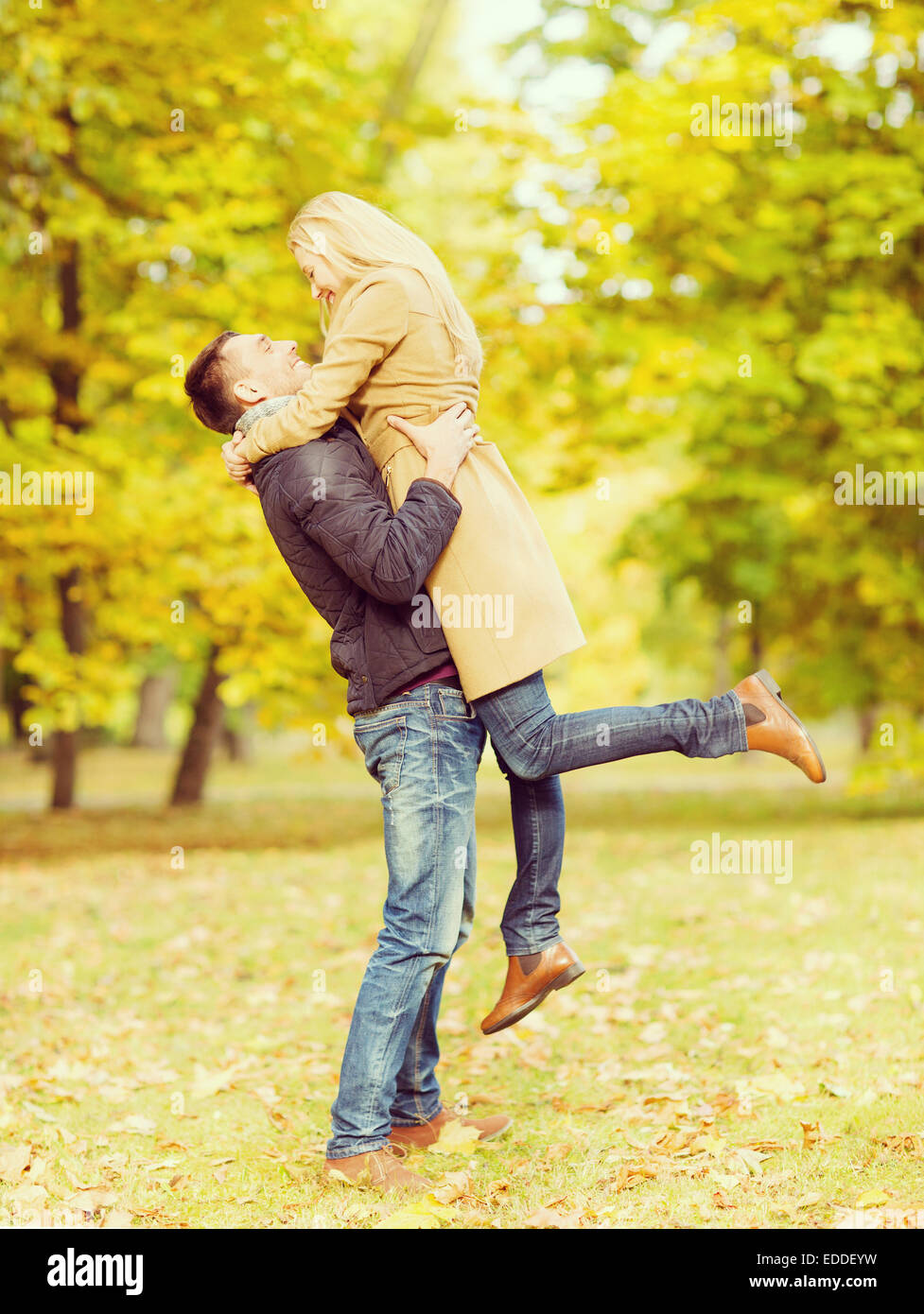romantic couple playing in the autumn park Stock Photo - Alamy