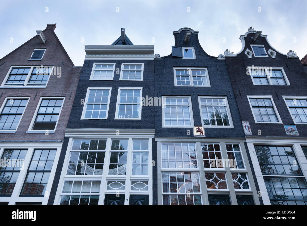 Netherlands, Amsterdam, four facades with divided light windows of residential houses Stock Photo