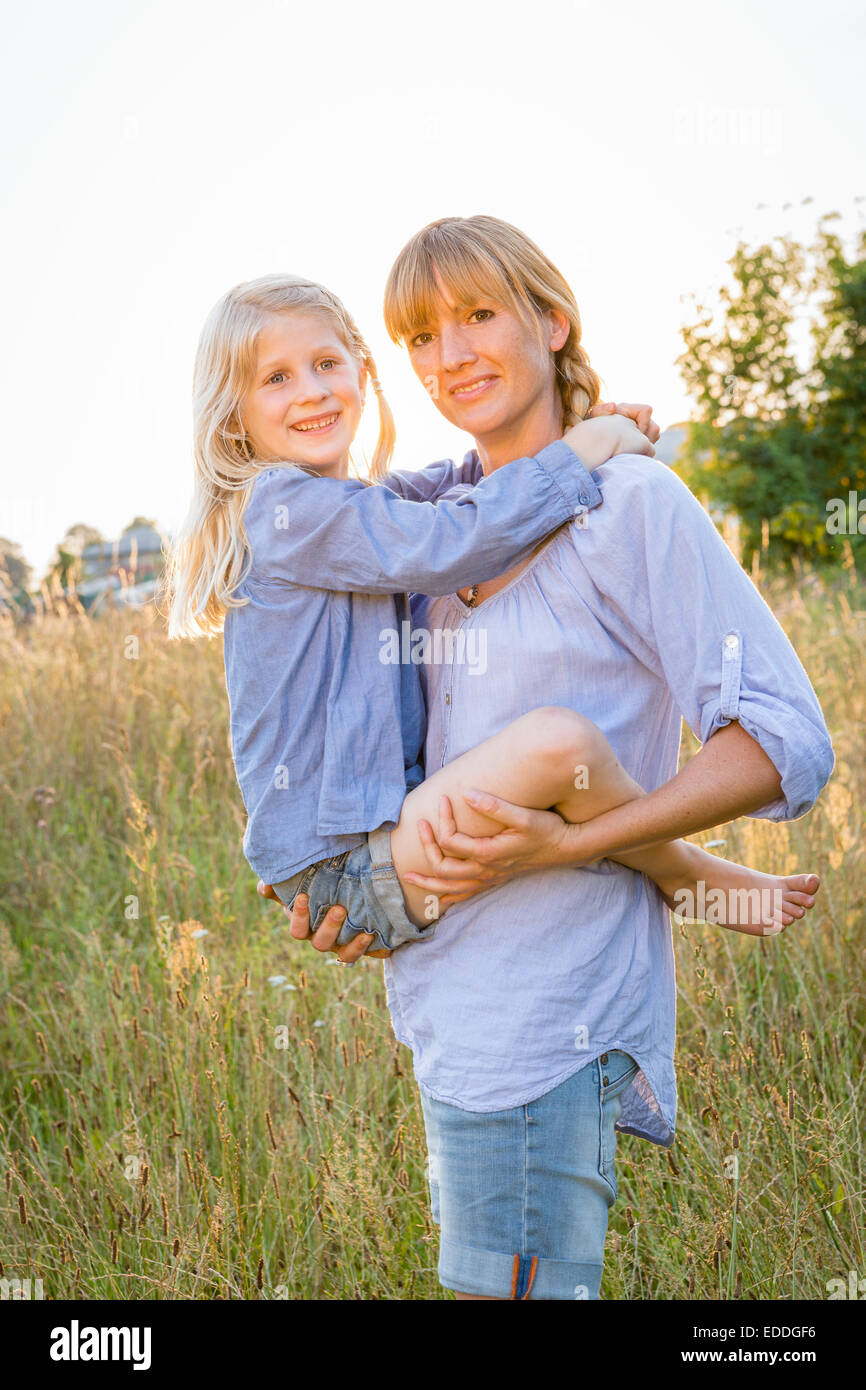 Mother and her little daughter enjoying country life Stock Photo