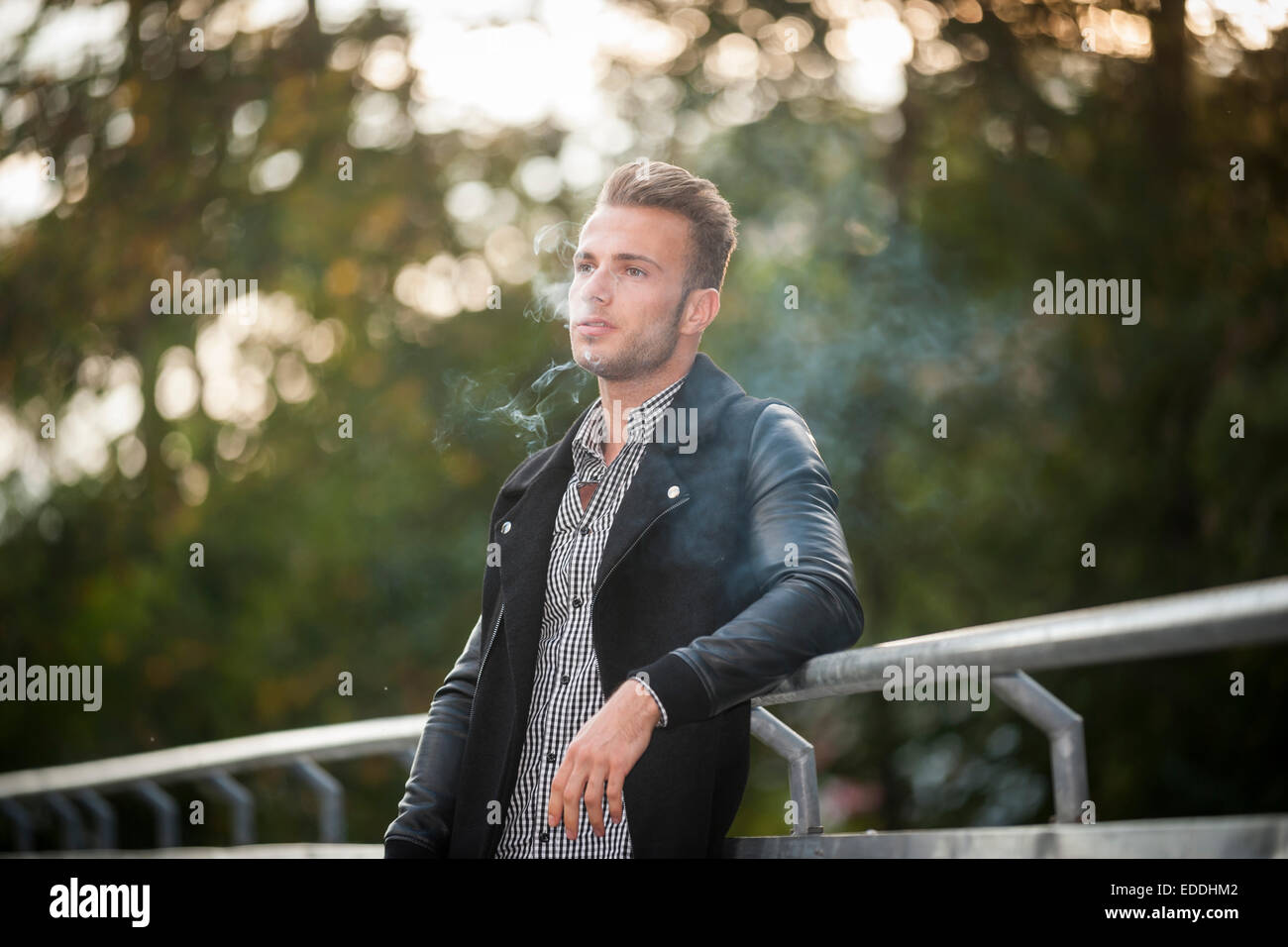 Portrait of young man smoking a cigarette Stock Photo