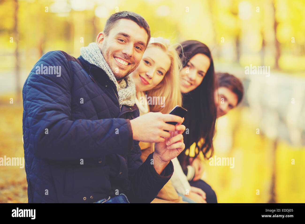 group of friends having fun in autumn park Stock Photo - Alamy