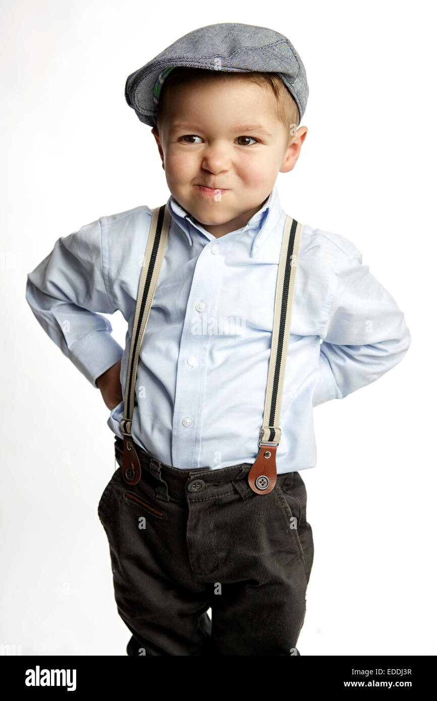 Little boy wearing cap and suspenders pouting mouth Stock Photo Alamy