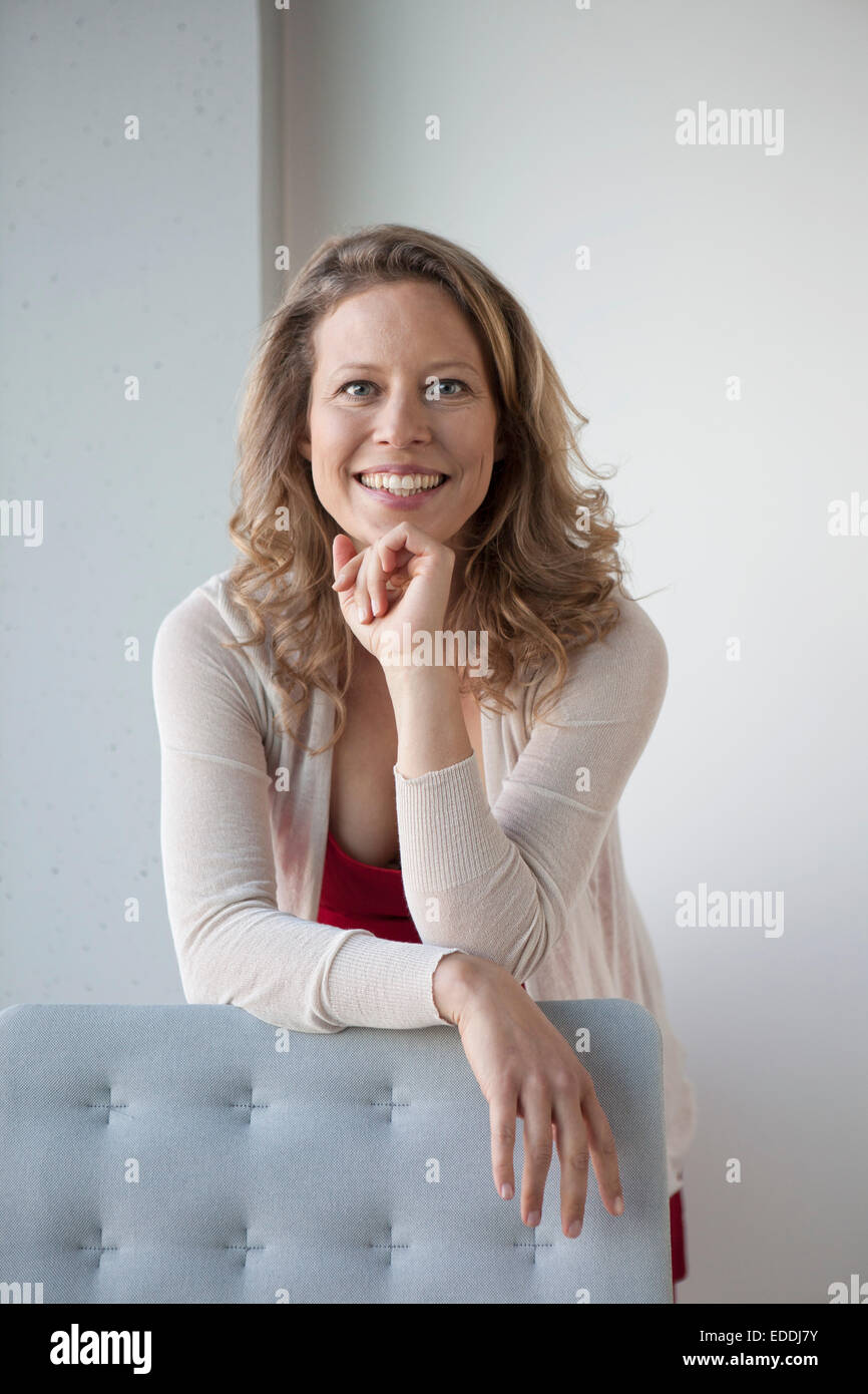 Portrait of smiling mature woman with hand on chin Stock Photo - Alamy