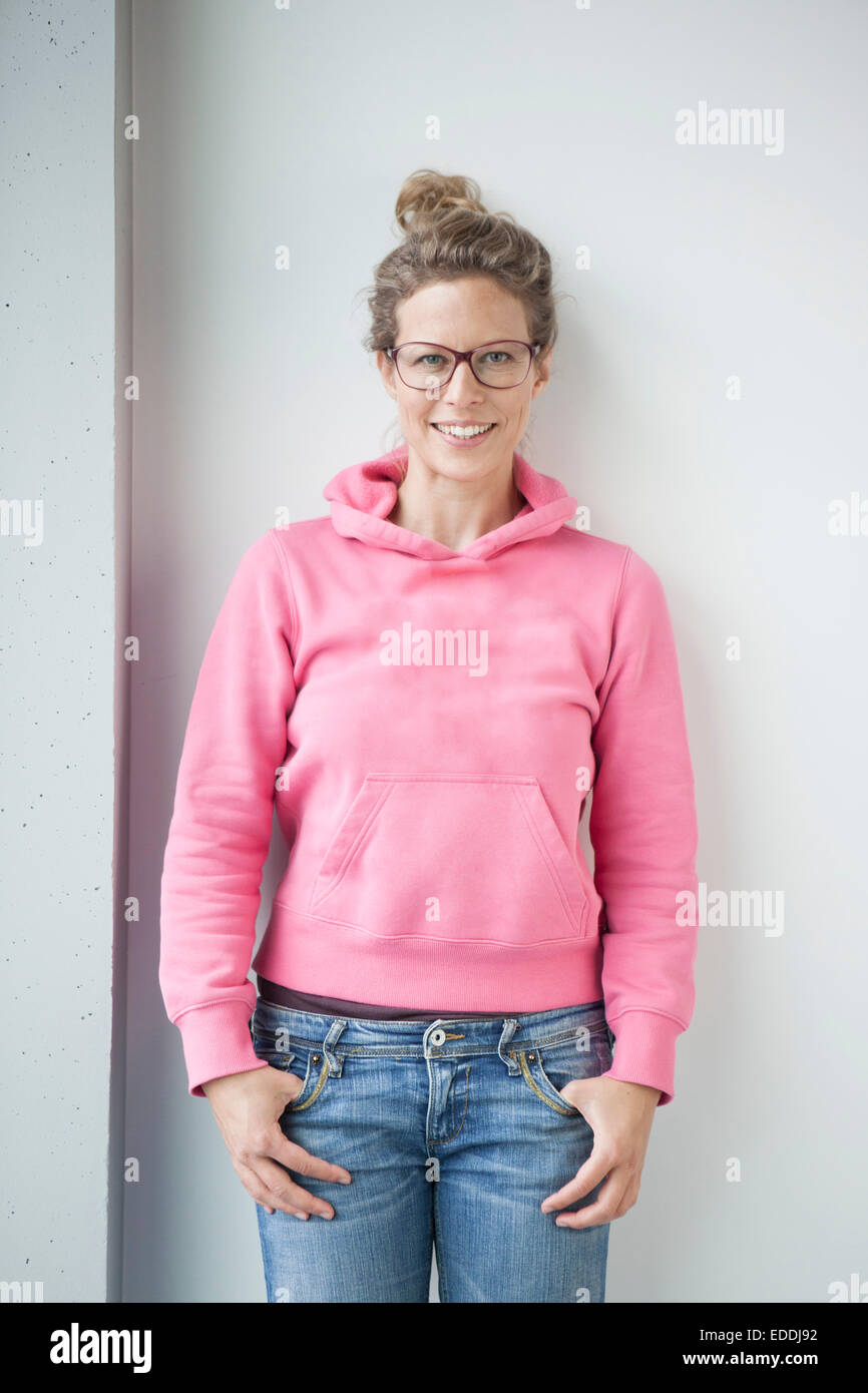 Portrait of smiling mature woman wearing pink hooded jacket Stock Photo ...