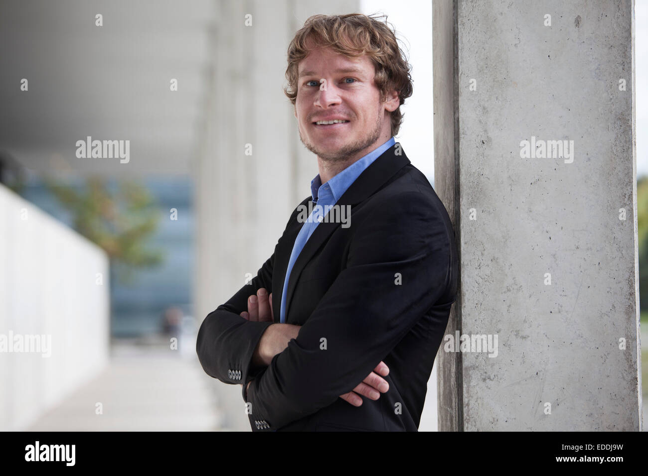Portrait of smiling businessman with crossed arms Stock Photo - Alamy