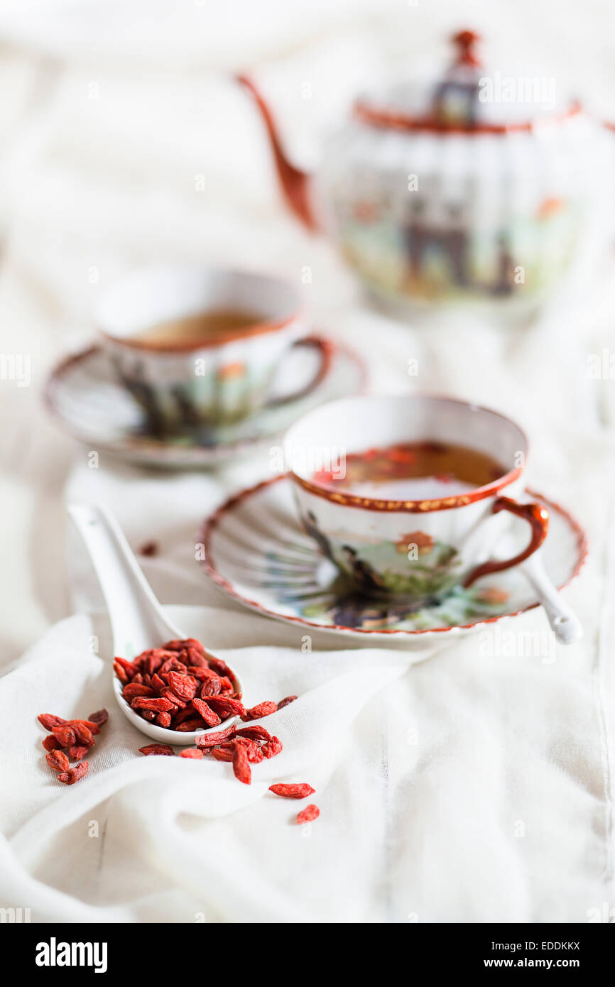 Cup of green tea with dried Goji berries, Lycium barbarum Stock Photo