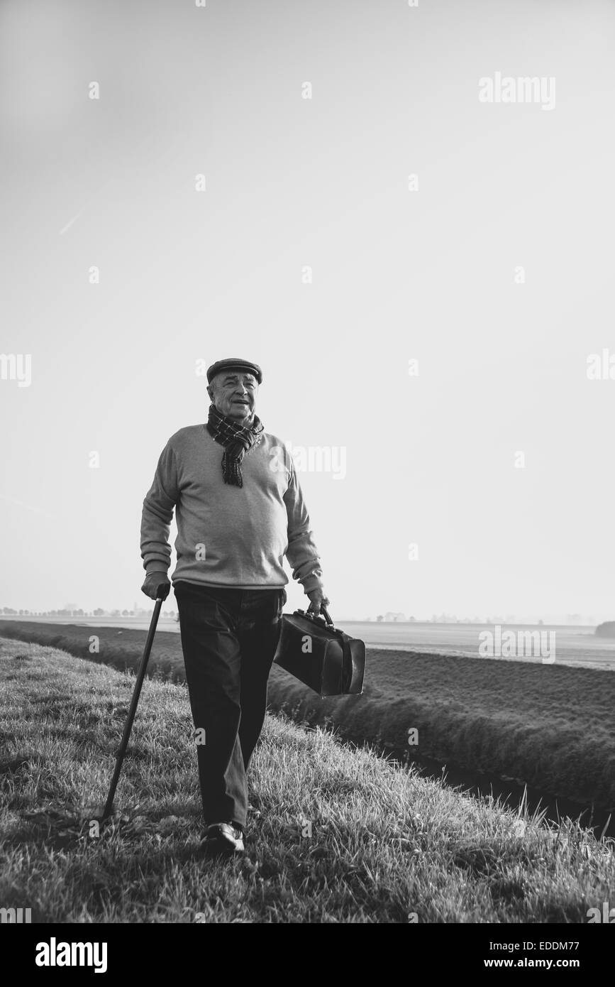 Old man walking stick bag hi-res stock photography and images - Alamy