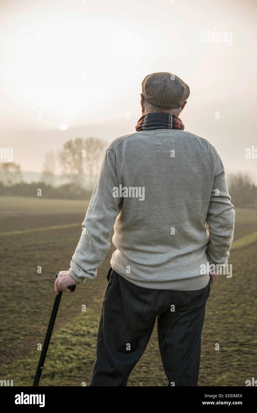 Senior man in rural landscape looking at view Stock Photo
