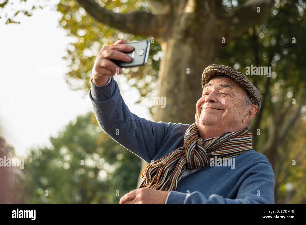 Smiling senior man taking a selfie Stock Photo