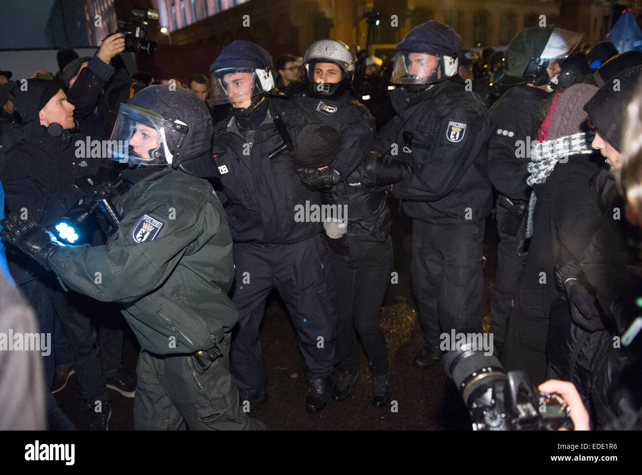 Berlin, Germany. 5th Jan, 2015. Riot police take action against protestors during a rally of the right-wing populist group 'Baergida' (Patriotic Berliners Against the Islamization of the West), in Berlin, Germany, 5 January 2015. The so-called Pegida group (Patriotic Europeans Against the Islamization of the West) has been staging rallys against the alleged alienation of Germany by foreigners in various city across the country for weeks ongoing. Several organisation have announced to organise counter rallys in protest of Pegida in Berlin. Photo: Bernd von Jutrczenka/dpa/Alamy Live News Stock Photo
