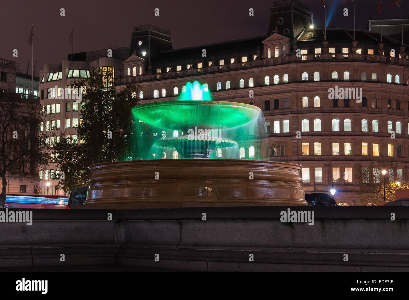Illuminated fountain on Trafalgar Square at night Stock Photo - Alamy