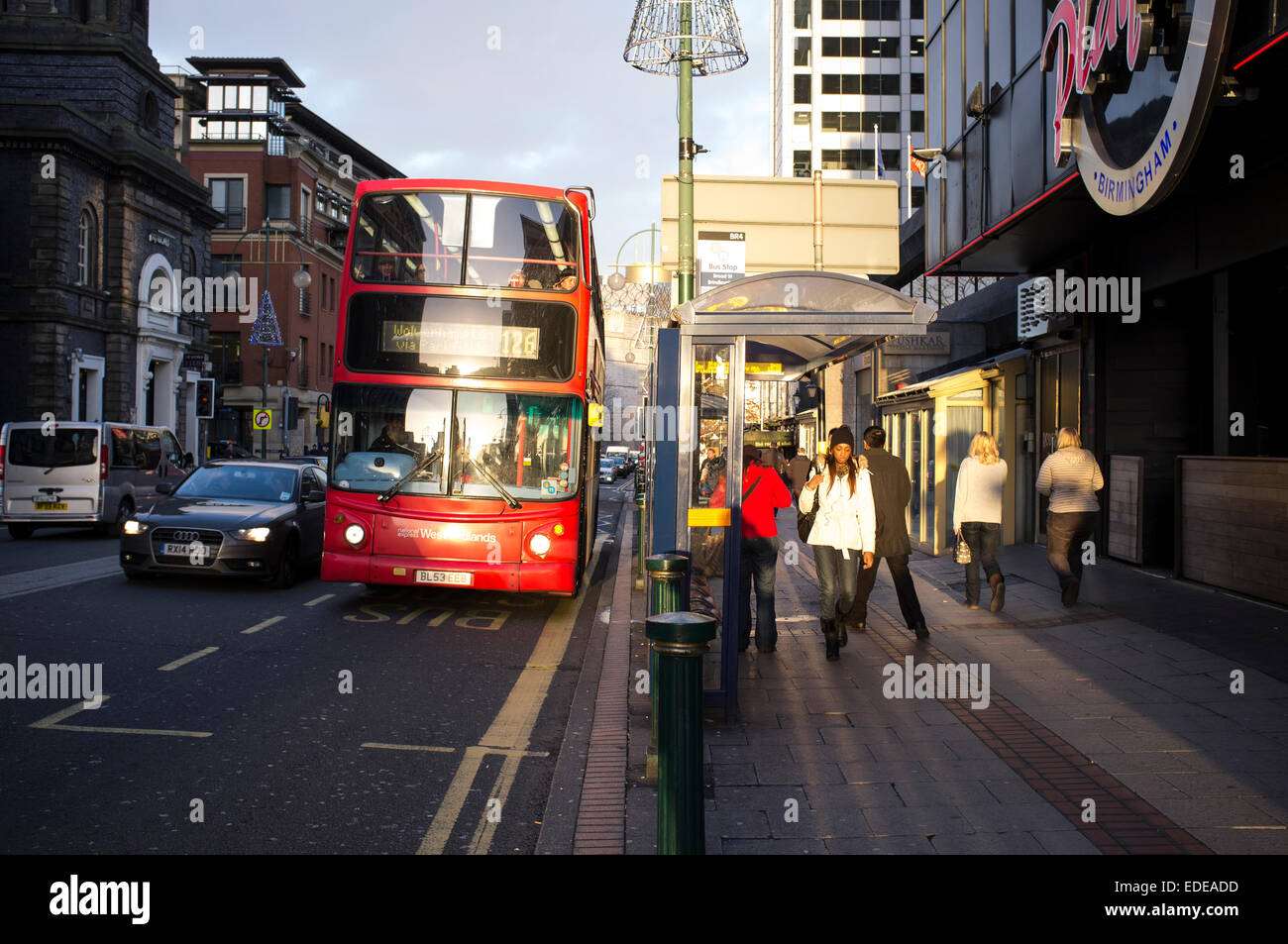 Car overtakes bus on narrow Broad Street, Birmingham. Everyday street scene Stock Photo