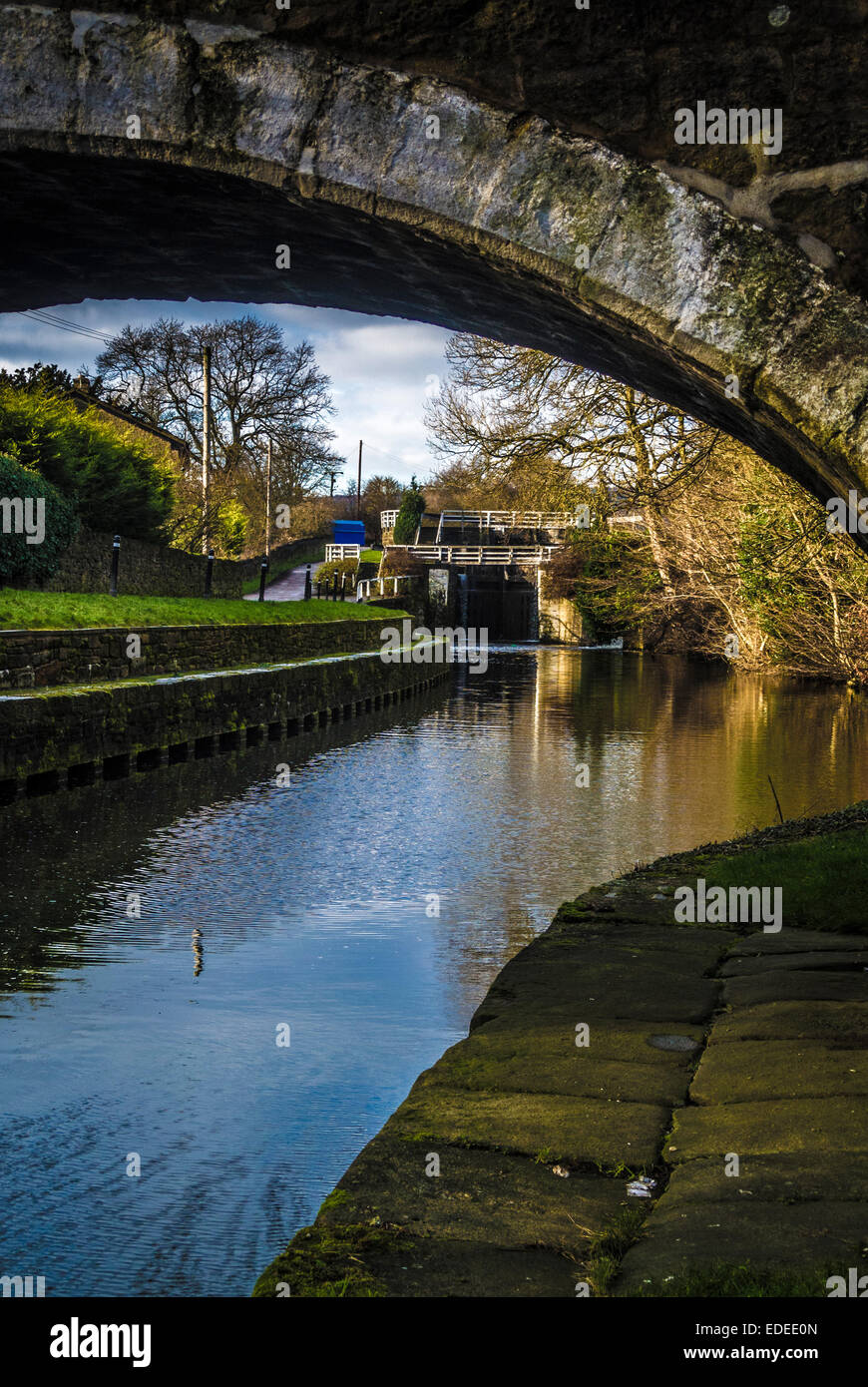 Doweley Gap Locks seen through bridge arch, Leeds Liverpool Canal. Stock Photo
