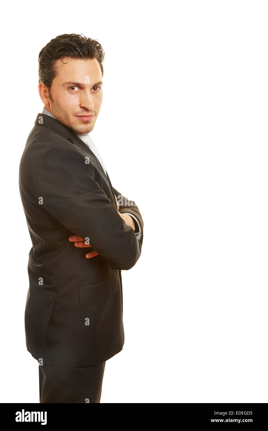Happy businessman with his arms crossed standing sideways Stock Photo