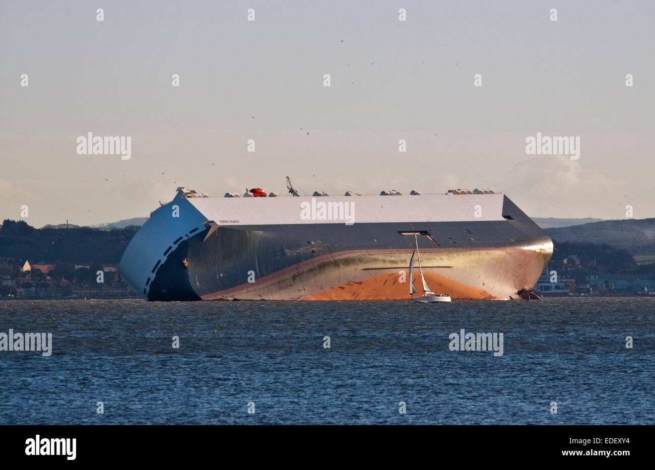 Solent, Hampshire, UK. 6th January, 2015. Hoegh Osaka Car Transporter Ship run aground on the Brambles Sandbank in the Solent, Hampshire, England - awaiting salvage plans - 06Jan15 Credit:  Krys Bailey/Alamy Live News Stock Photo