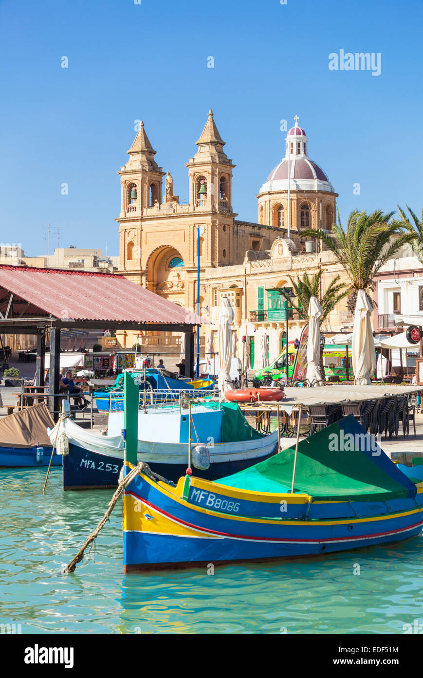 Marsaxlokk Harbour Our Lady of Pompeii Church and traditional fishing boats Marsaxlokk Malta EU Europe Stock Photo