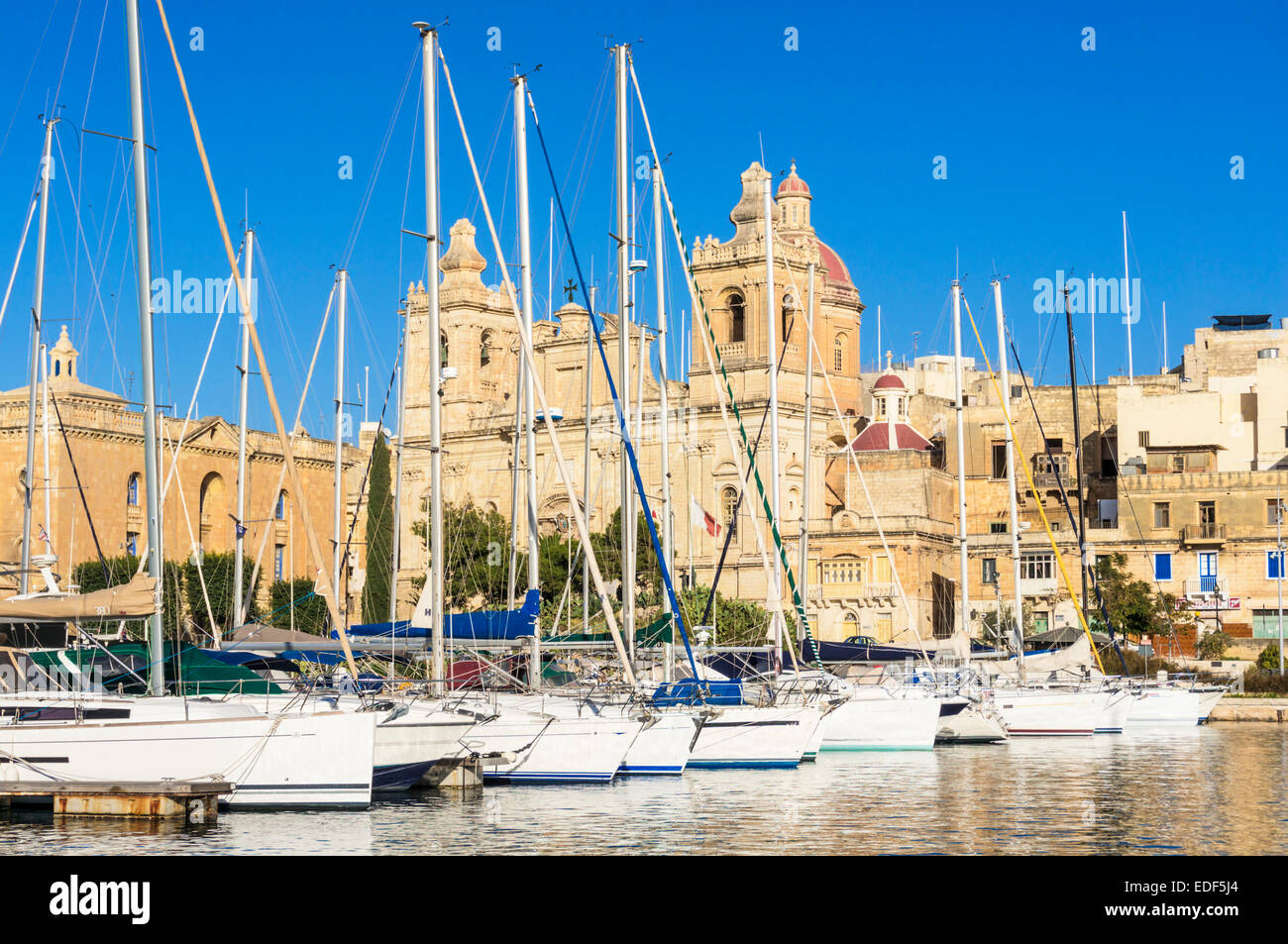 Vittoriosa waterfront wharf and St Lawrence's Church Vittoriosa Harbour Malta EU Europe Stock Photo
